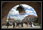 Svatební hosté procházejí podloubím